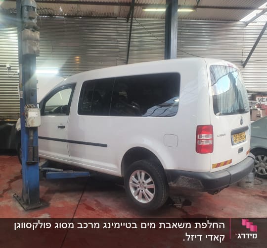 רכב לבן במוסך על מעלית הרמה